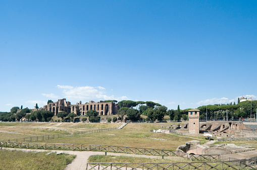 View of the Circus Maximus in Rome. The tower in the foreground is part of a medieval fortification. The Circus Maximus was a chariot racing stadium and a mass entertainment venue in ancient Rome.
