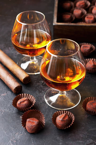 istock Whiskey or cognac  in  glass with  truffles candy on  dark background 1264526173