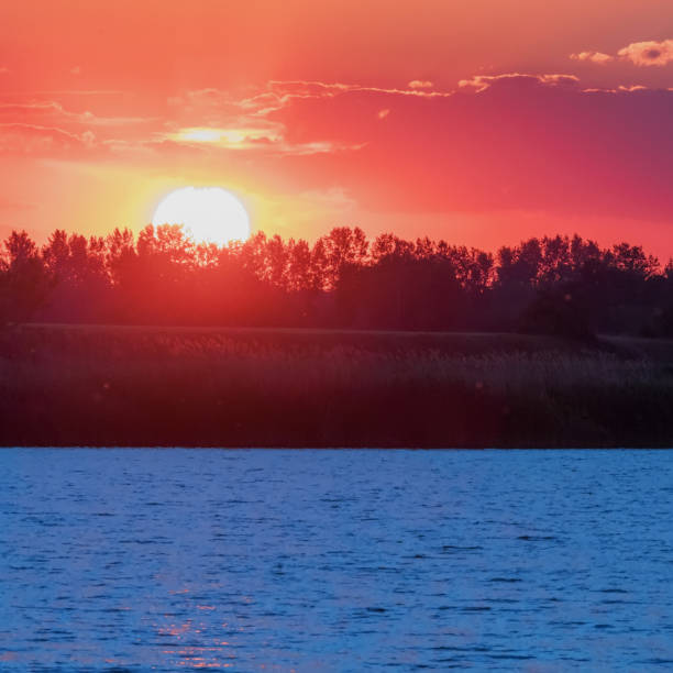 istock Sunset Scene over Lake, Water Surface Sunset 1264527340