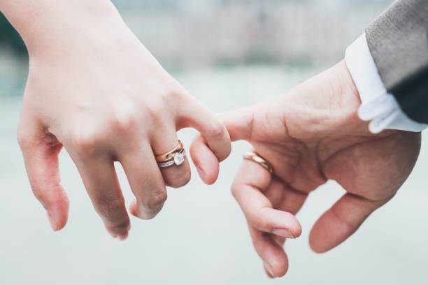 Couple promise love of the eternity Unrecognizable newlywed couple doing a pinky promise ring jewelry photos stock pictures, royalty-free photos & images