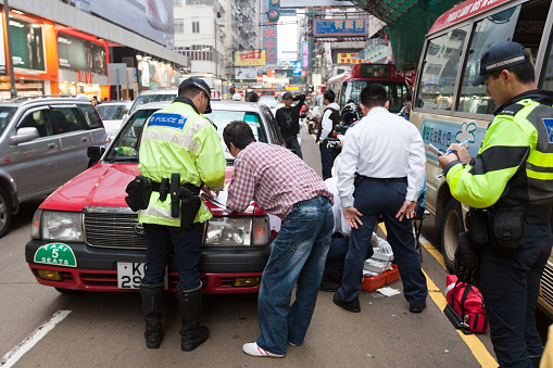 Police survey the scene of the car accident in Mong Kok, Kowloon, Hong Kong.
