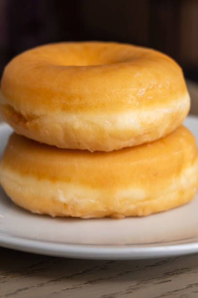 istock Two fresh donuts for breakfast on a wooden table 1264532147