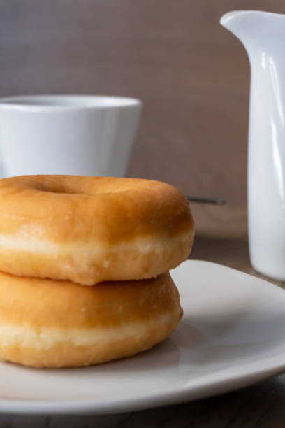 istock Two fresh donuts for breakfast on a wooden table 1264532152
