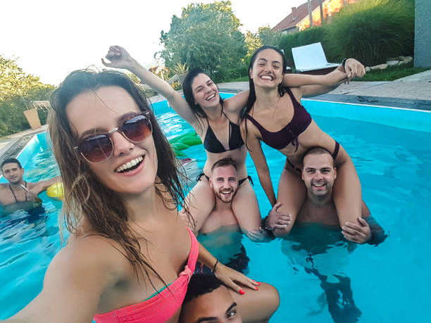 istock Selfie with friends at a poolside party 1264532392