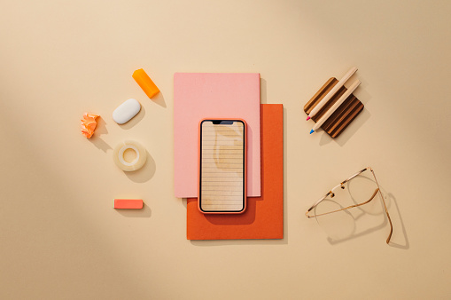 Back to School: a Neat Flat Lay Minimalistic Still Life Composition of School Supplies (Books, Sticky Notes, Pens, Technology)