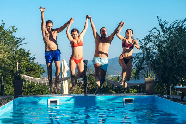 istock Friends jumping in swimming pool 1264533566
