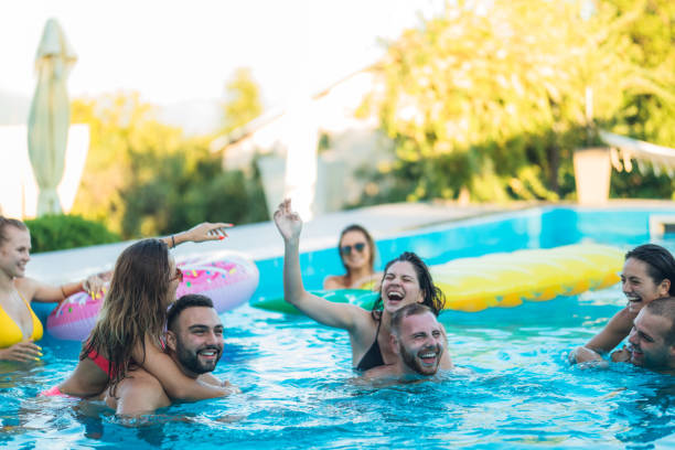 istock Friends at a poolside party 1264533673