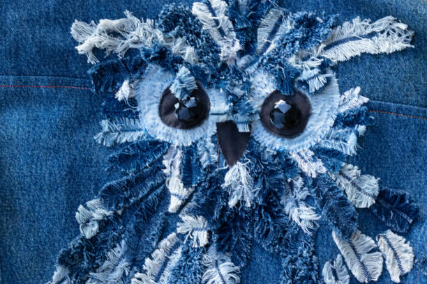 Blue denim jeans patchwork pattern. Concept of old jeans reuse and natural resources preserving.