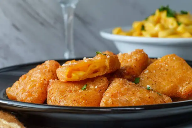 Battered and deep-fried macaroni and cheese wedges appetizer