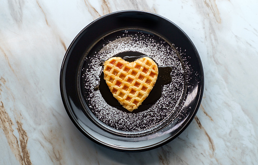 Heart shaped breakfast waffle for Valentine's day romance concept