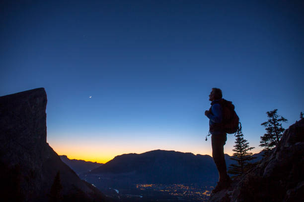 istock Mountaineer looks off from mountain ridge 1264538825