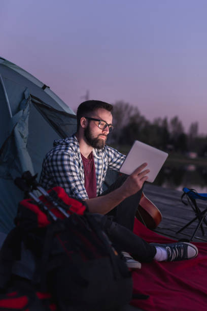 istock Man camping on the lake 1264539032