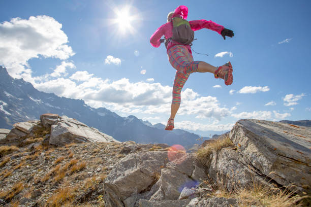 istock Trail runner ascends high mountain ridge 1264540777