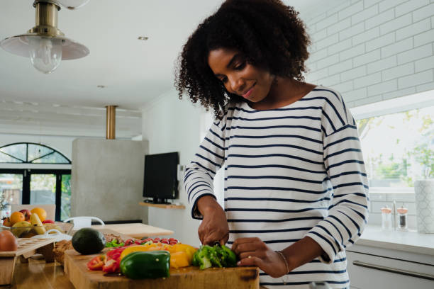 istock mixed-race female making food in the kitchen 1264540843