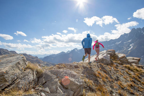 istock Trail runners ascend high mountain ridge 1264542042