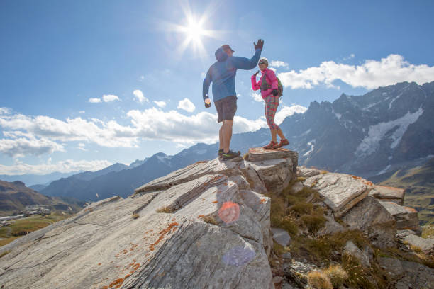 istock Trail runners ascend high mountain ridge 1264542434