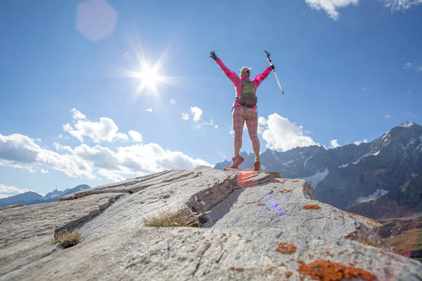 istock Trail runner reaches summit of high mountain ridge 1264542467
