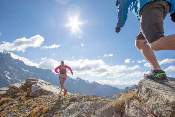 istock Trail runners ascend high mountain ridge 1264542743