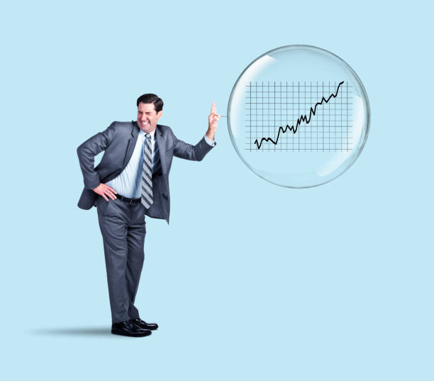 Businessman Popping The Stock Market Bubble A businessman uses a pin to pop a stock market bubble. Bubble Bursting in Share Market stock pictures, royalty-free photos & images
