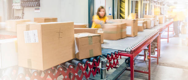 istock Blurred motion photo of postal workers handling packages 1264545074