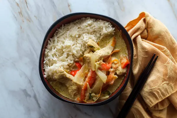Thai food spicy coconut milk yellow curry soup with chicken and rice