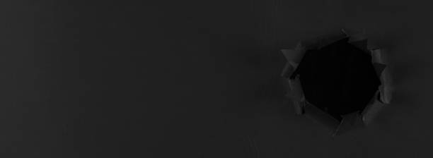 istock black abstract paper background with black torn hole 1264545990