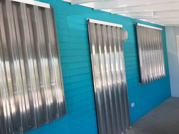 Hurricane shutters cover the windows and doors on a small cottage in Florida. stock photo