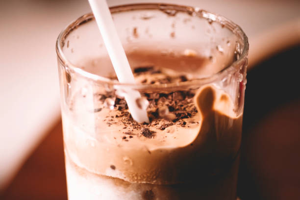 istock home made Dalgona coffee glass with straw side close up photo 1264546303