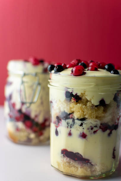 Berry trifle served in mason jars stock photo