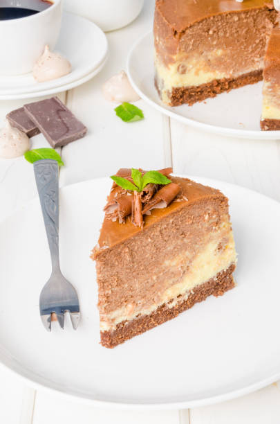 istock Marble chocolate coffee cheesecake with meringue, marshmallow and chocolate on top on white wooden background. 1264548151