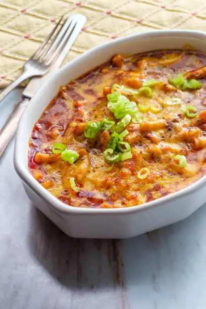 Baked American goulash one-pot meal cheesy beef and macaroni pasta in casserole dish