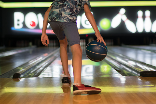 Happy boy playing bowling