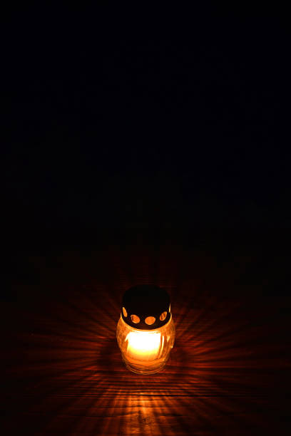 istock Votive candle on dark background. All Saints Day candle 1264549590