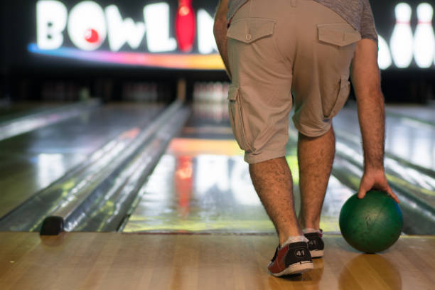 istock Man throw ball at bowling lane. 1264550317