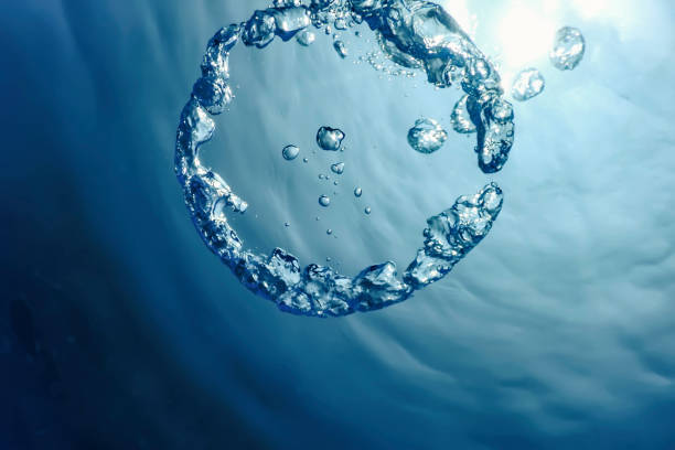 istock Bubble Ring Underwater ascends towards the Sun. 1264551911