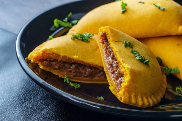 Jamaican Beef Turnover Spicy Jamaican beef turnovers with mint garnish Jamaican Beef Patty stock pictures, royalty-free photos & images