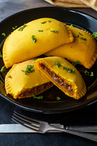 Spicy Jamaican beef turnovers with mint garnish