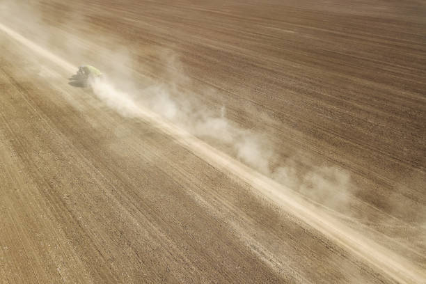istock Aerial View Dirt road crossing Plowed Field 1264553044