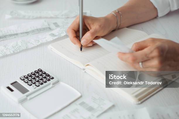 Counting On A Calculator From A Check And Bookkeeping Remotely Stock Photo - Download Image Now