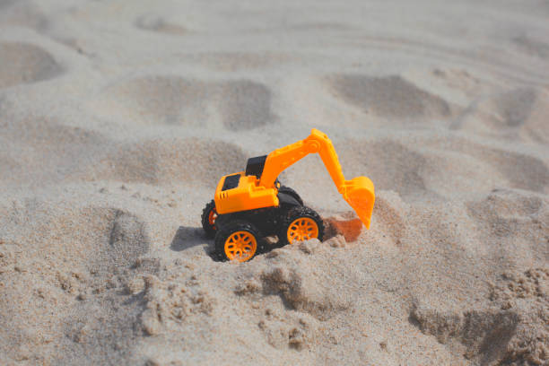 istock Toy excavator on the beach 1264555531
