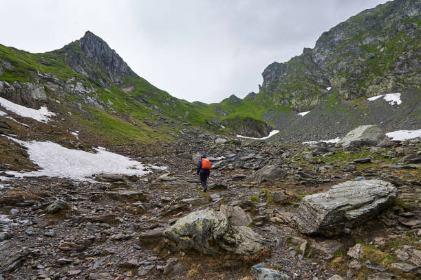 istock Woman hiker on a trail in the mountains 1264557219