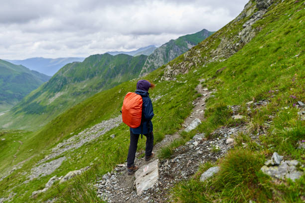 istock Lady hiker on a trail in the mountains 1264557248
