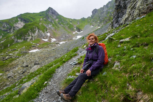 istock Woman backpacker resting on the trail 1264557290