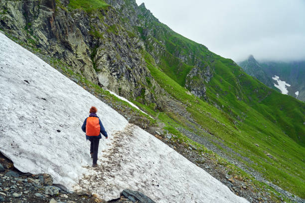 istock Lady hiker on a trail in the mountains 1264557921
