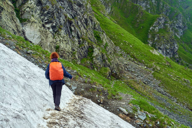 istock Lady hiker on a trail in the mountains 1264557923