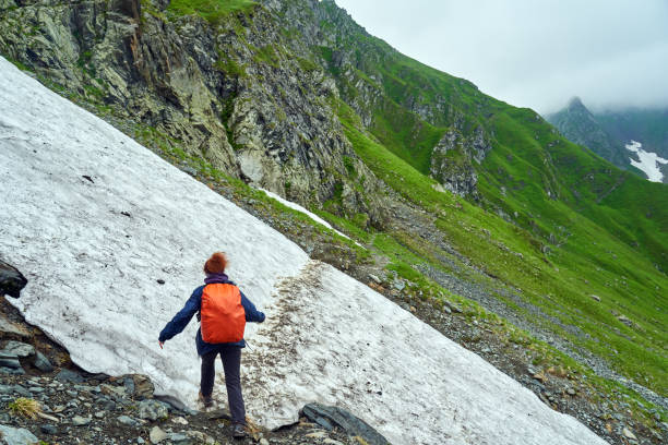 istock Lady hiker on a trail in the mountains 1264557925