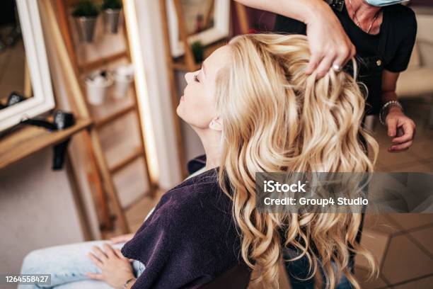 Woman With Protective Mask Receiving Treatment In Hair Salon Stock Photo - Download Image Now