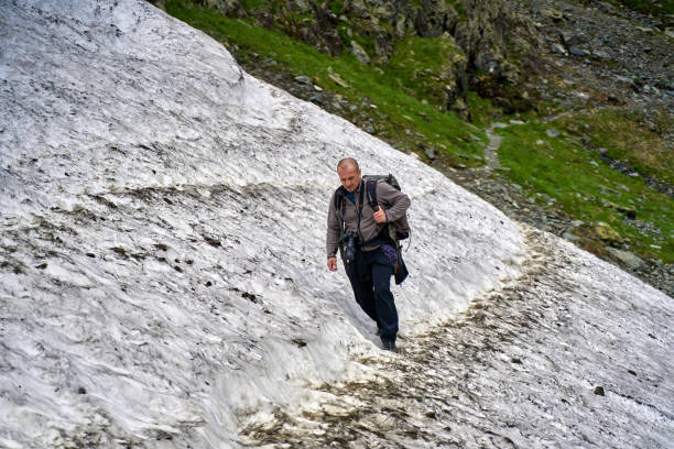 istock Hiker on the summer snow trail 1264558455