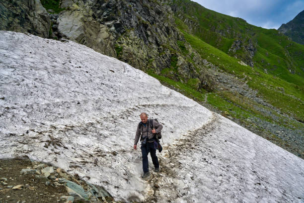 istock Hiker on the summer snow trail 1264558458