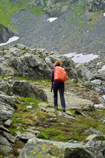 istock Lady hiker on a trail in the mountains 1264558463